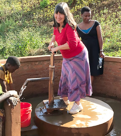 By contrast, Dr Susan Wilson is pictured here with one of the Tumaini clean water wells – June 2019.